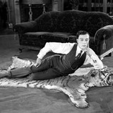 1924: American comedian Buster Keaton (1895-1966) lying on a tigerskin rug in his latest film 'The N
