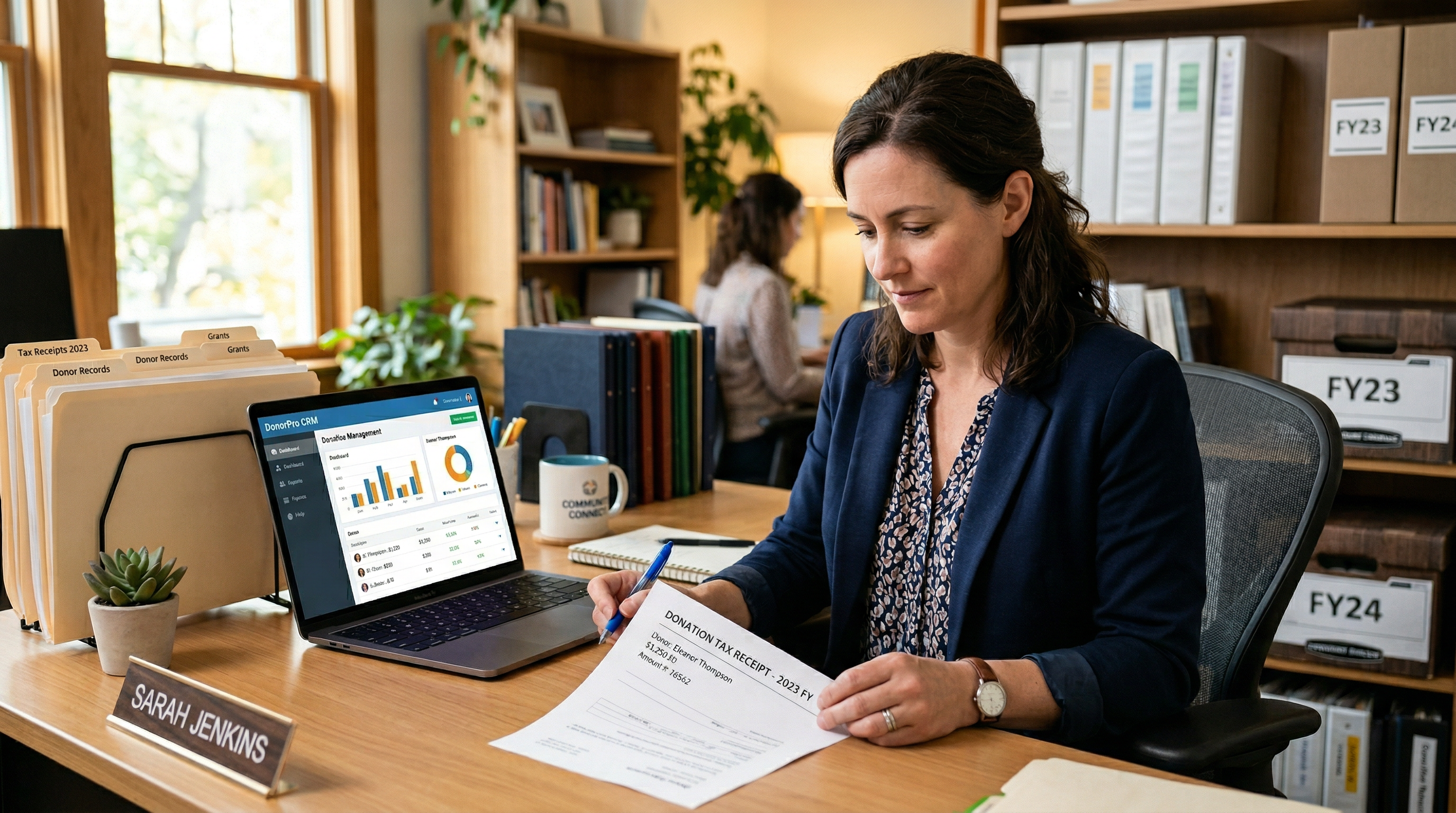 Nonprofit administrator reviewing tax receipt document at desk
