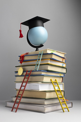 front view stacked books graduation cap ladders education day.jpg