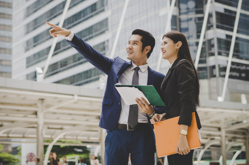 business colleague talking viewing documents outdoor.jpg