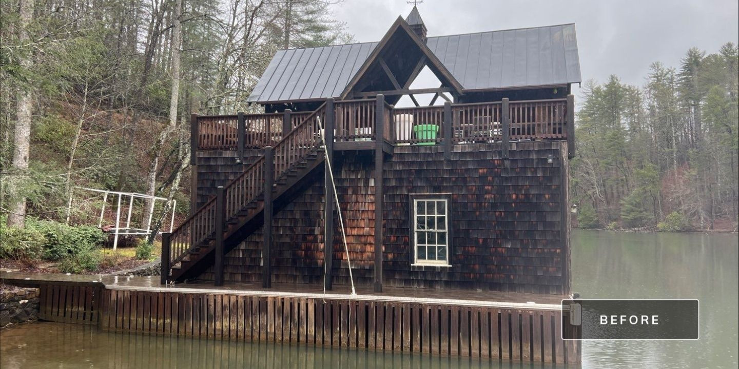 Cedar shake boathouse before soft wash cleaning showing dark algae and weathering on siding