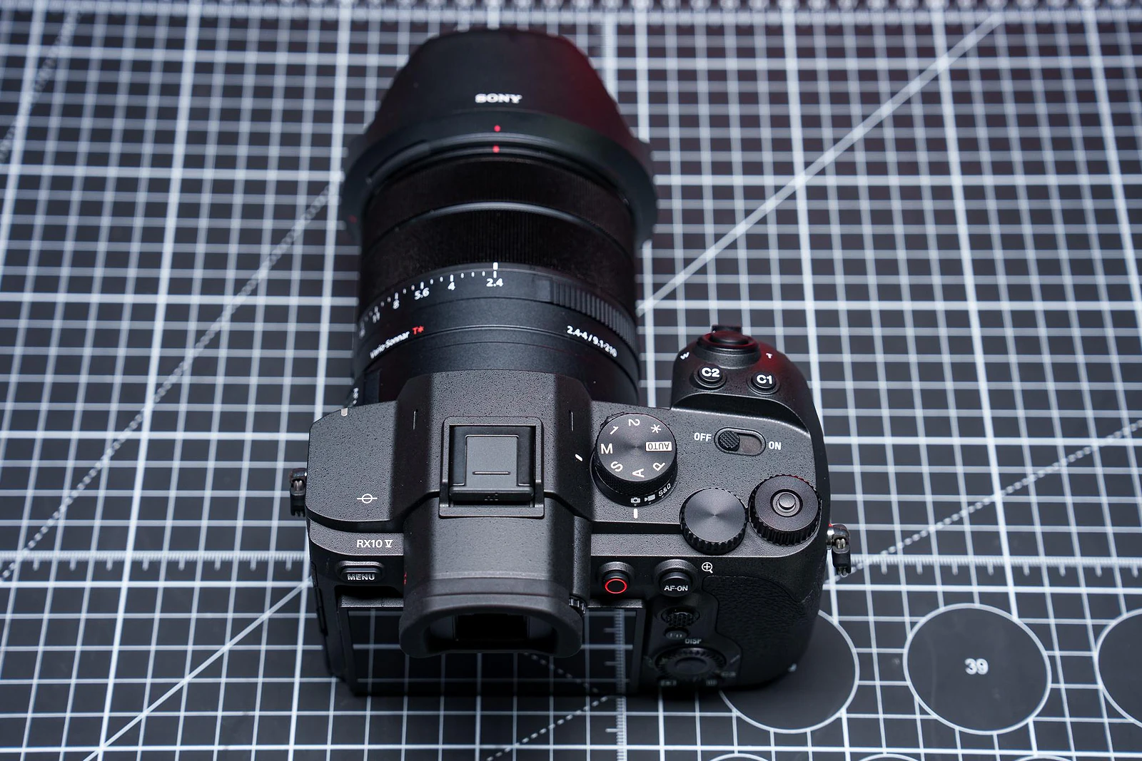 <em>The top deck takes more cues from the Alpha line, including a locking dial for functions like exposure compensation.</em>
