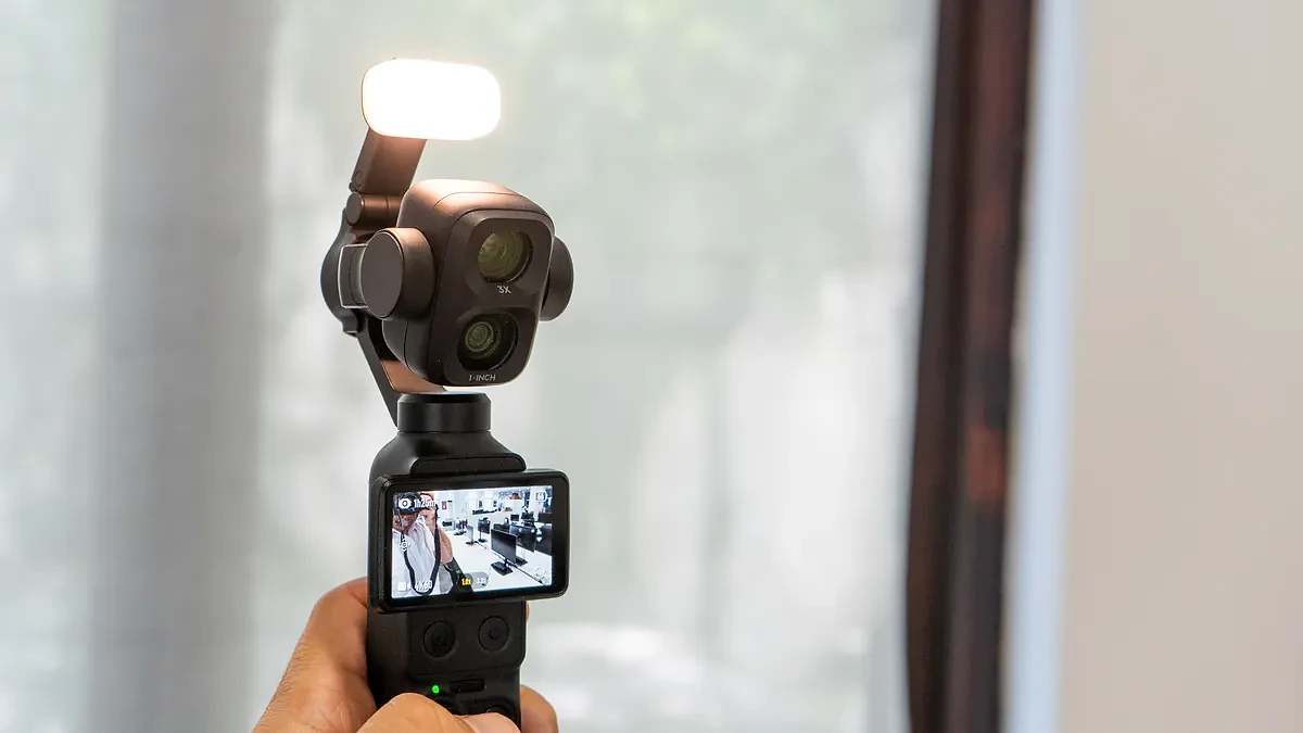 DJI Osmo Pocket 4P with the fill light accessory in my hand