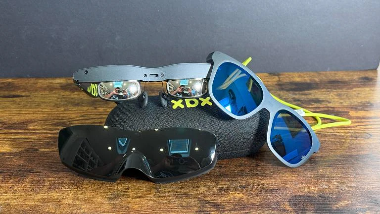 Xreal X by Xreal a01 glasses without face plate snapped on, with two face plates on a hard glasses case