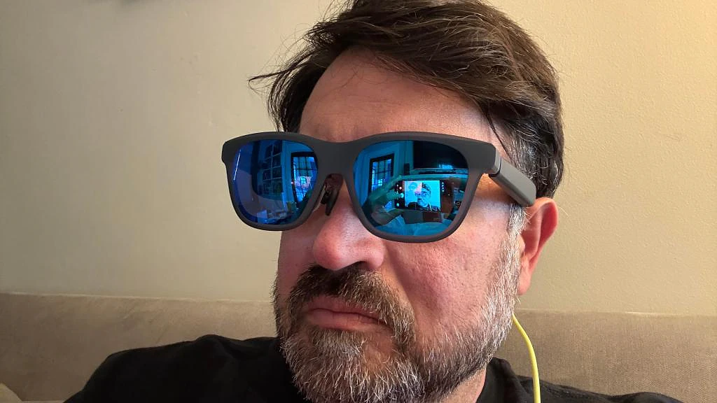 Scott Stein wearing X by Xreal a01 glasses on his face