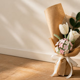white crochet tulip bouquet kraft wrapping on floor