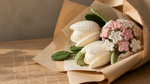 miniature white crochet tulip in kraft paper close up.jpg