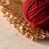 deep red crochet yarn on honeycomb wrapping mesh