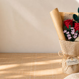 red crochet rose bouquet honeycomb wrapping on desk