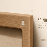 spinus studio minimalist wood engraved logo detail