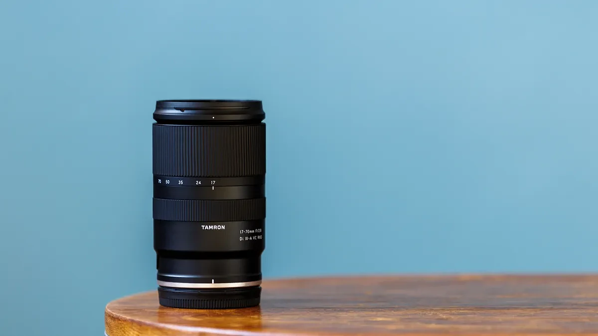 The Tamron 17-70mm f/2.8 Di III-A VC RXD sitting on a wooden table