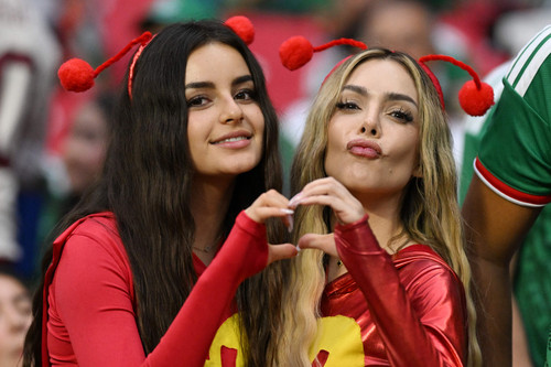Mexican fans dressed as TV character El Chapulin Colorado make a heart with their hands during the 2.jpg