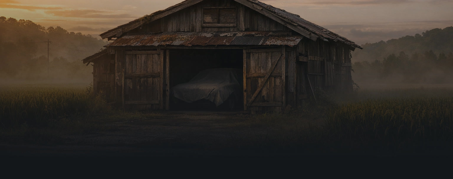 Abandoned Japanese barn at golden hour with a covered classic car silhouette