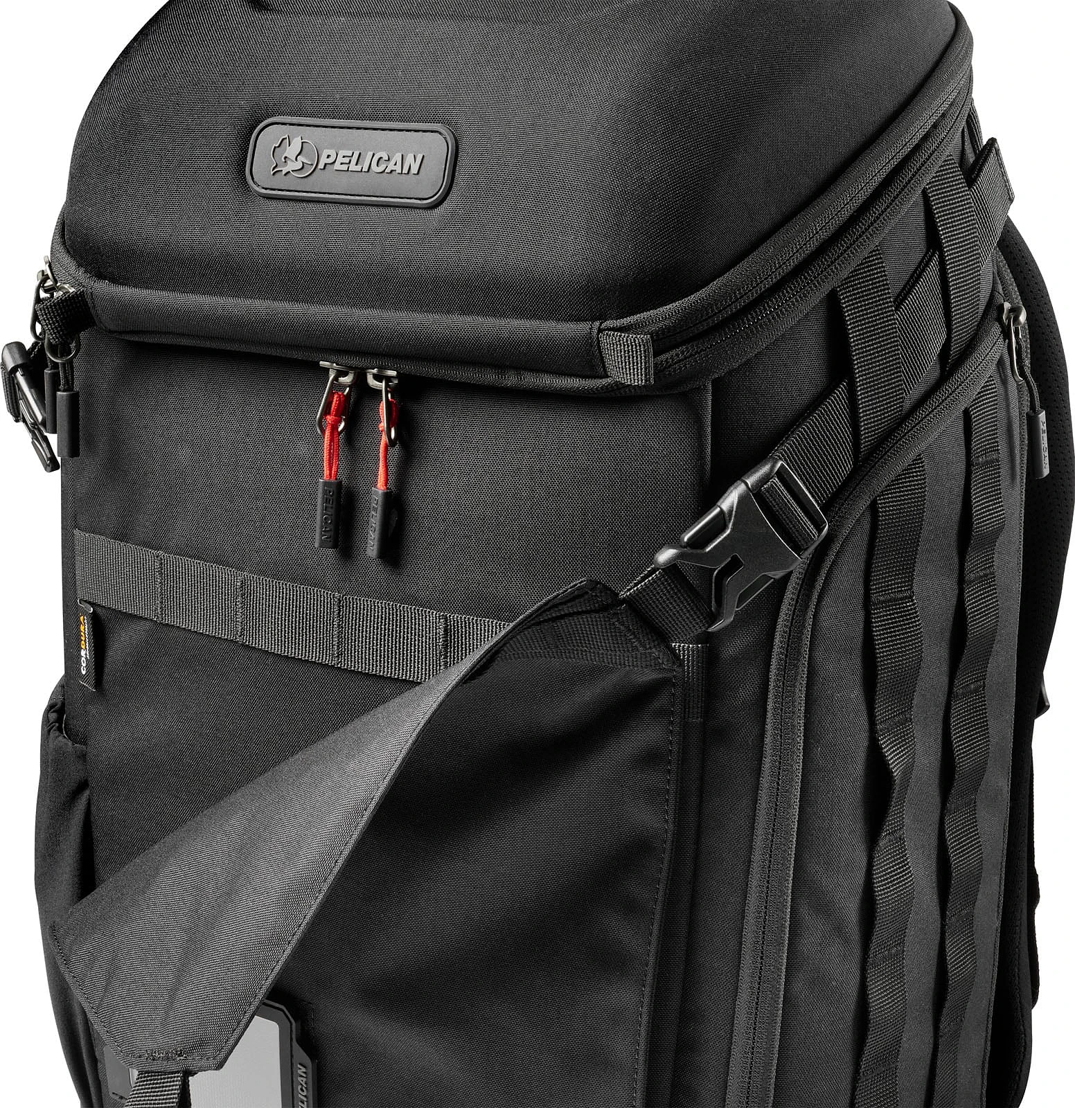 A black Pelican backpack featuring a top compartment, red zipper pulls, and a partially open front pocket with a visible logo.