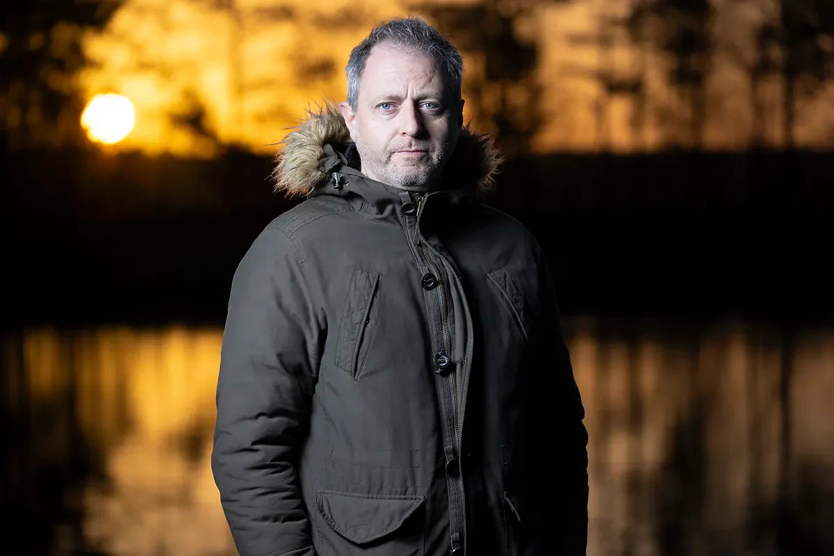 Flash portrait with golden sunrise and lake backdrop