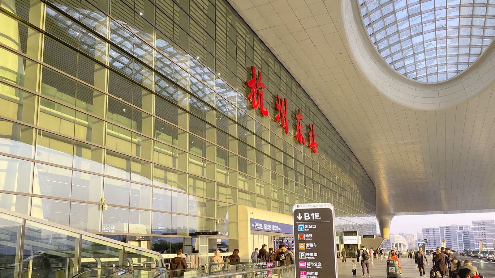 Interior of a clean modern Chinese metro train with empty red seats and Chinese characters on the wall