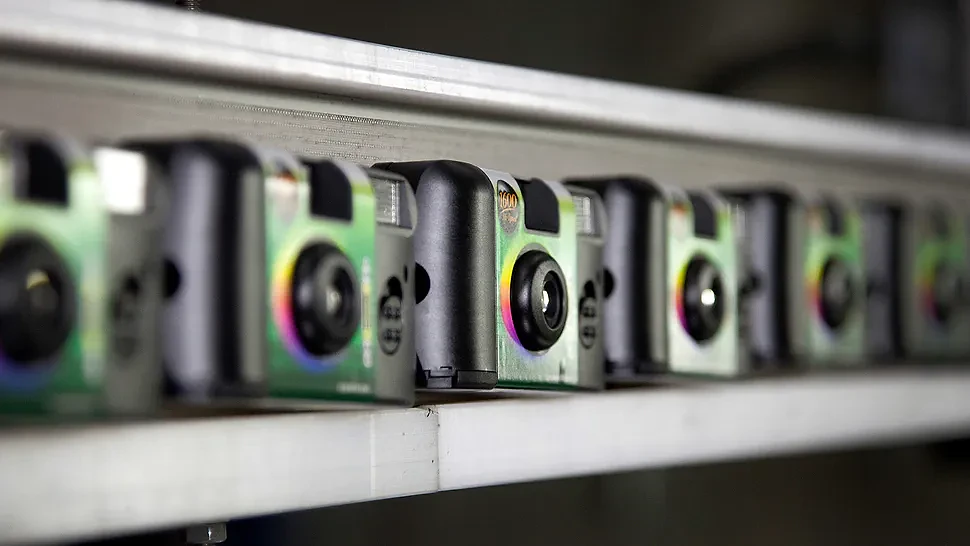 Finished Fujifilm Holdings Corp. QuickSnap disposable cameras move along a conveyor belt at the company's production facility in Greenwood, South Carolina, U.S., on Thursday, Jan. 12, 2012. Photographer: Ariana Lindquist/Bloomberg via Getty Images