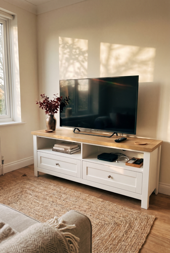 White TV unit with an oak-effect top for a panelled living room.png