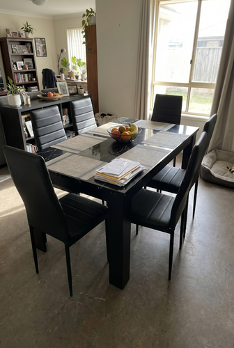 Black marble dining table and 6 chairs with high-back seating.png