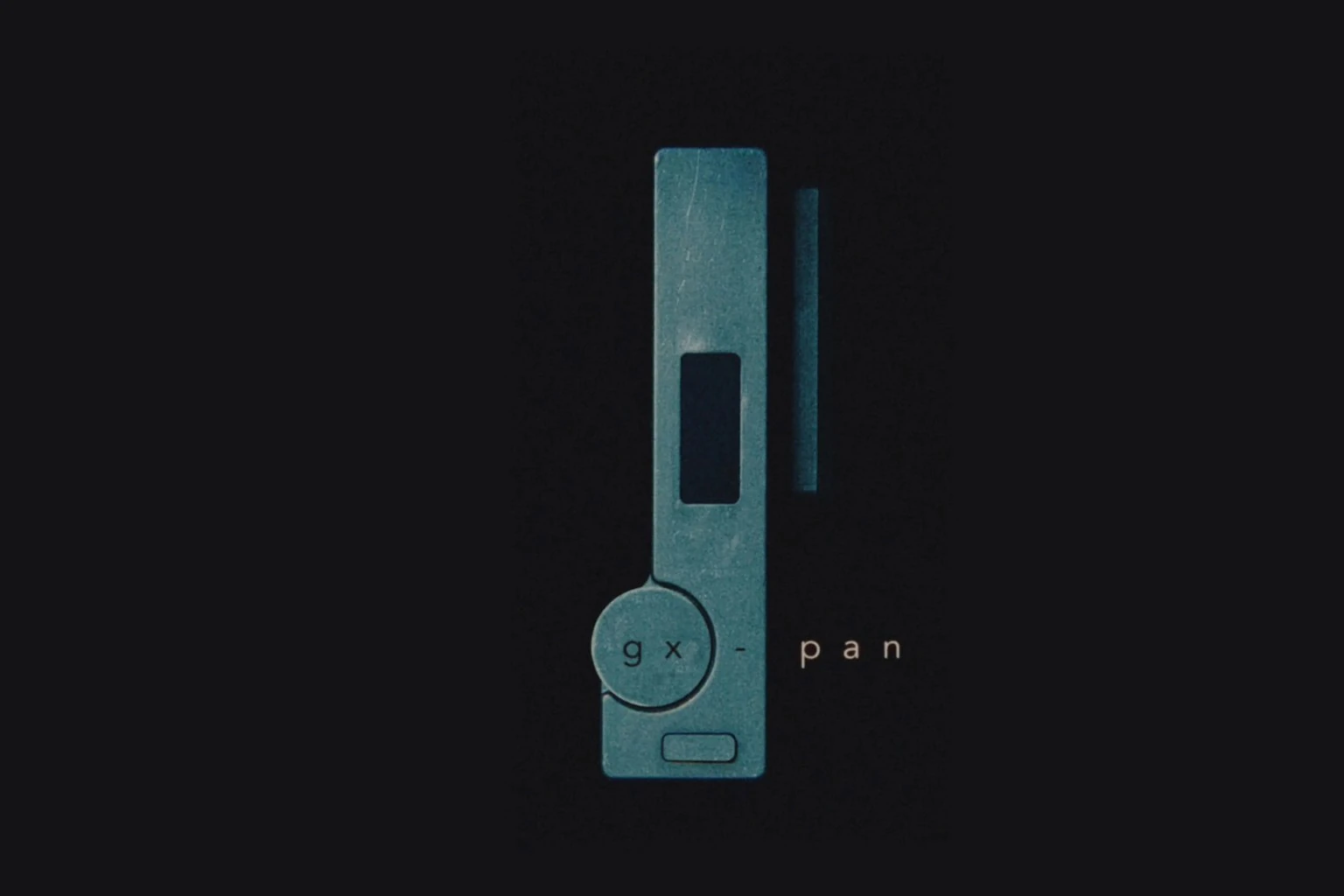 A top-down image of a small camera against a dark background, with the title GX-Pan.