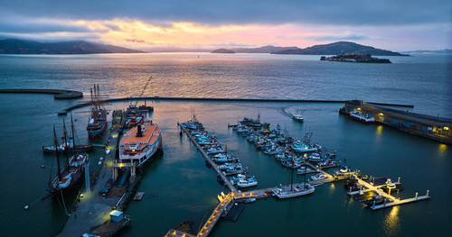 Image of Sunset lighting over San Francisco Bay with Alcatraz and Hyde St Pier lit up at night aeria.jpg