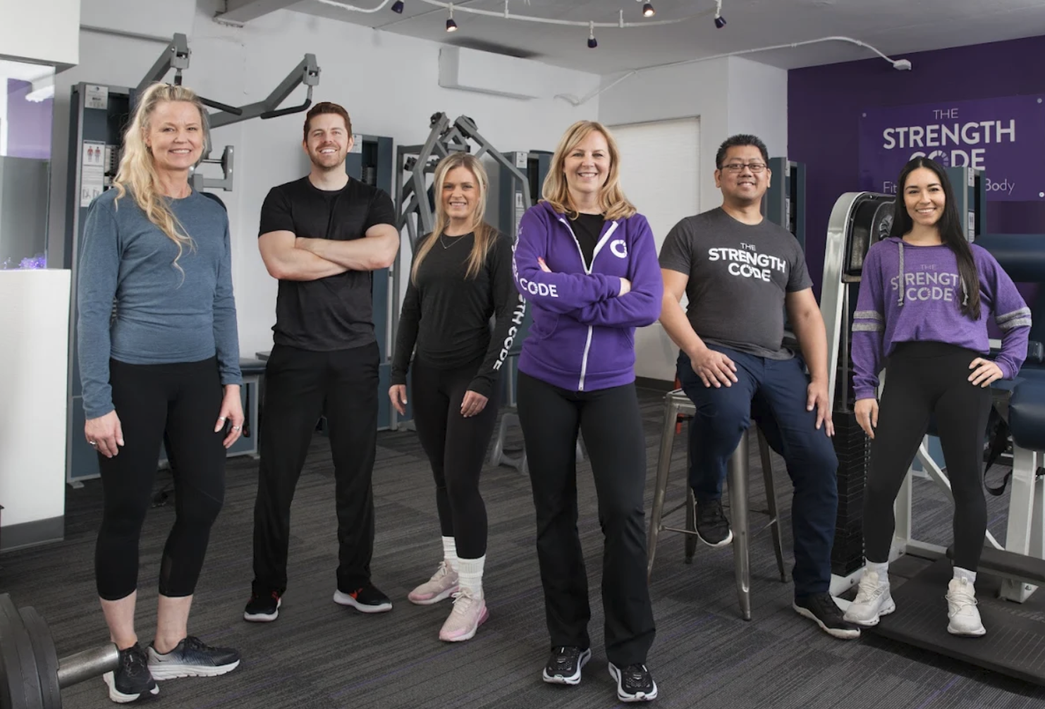 The Strength Code team standing together on the studio training floor
