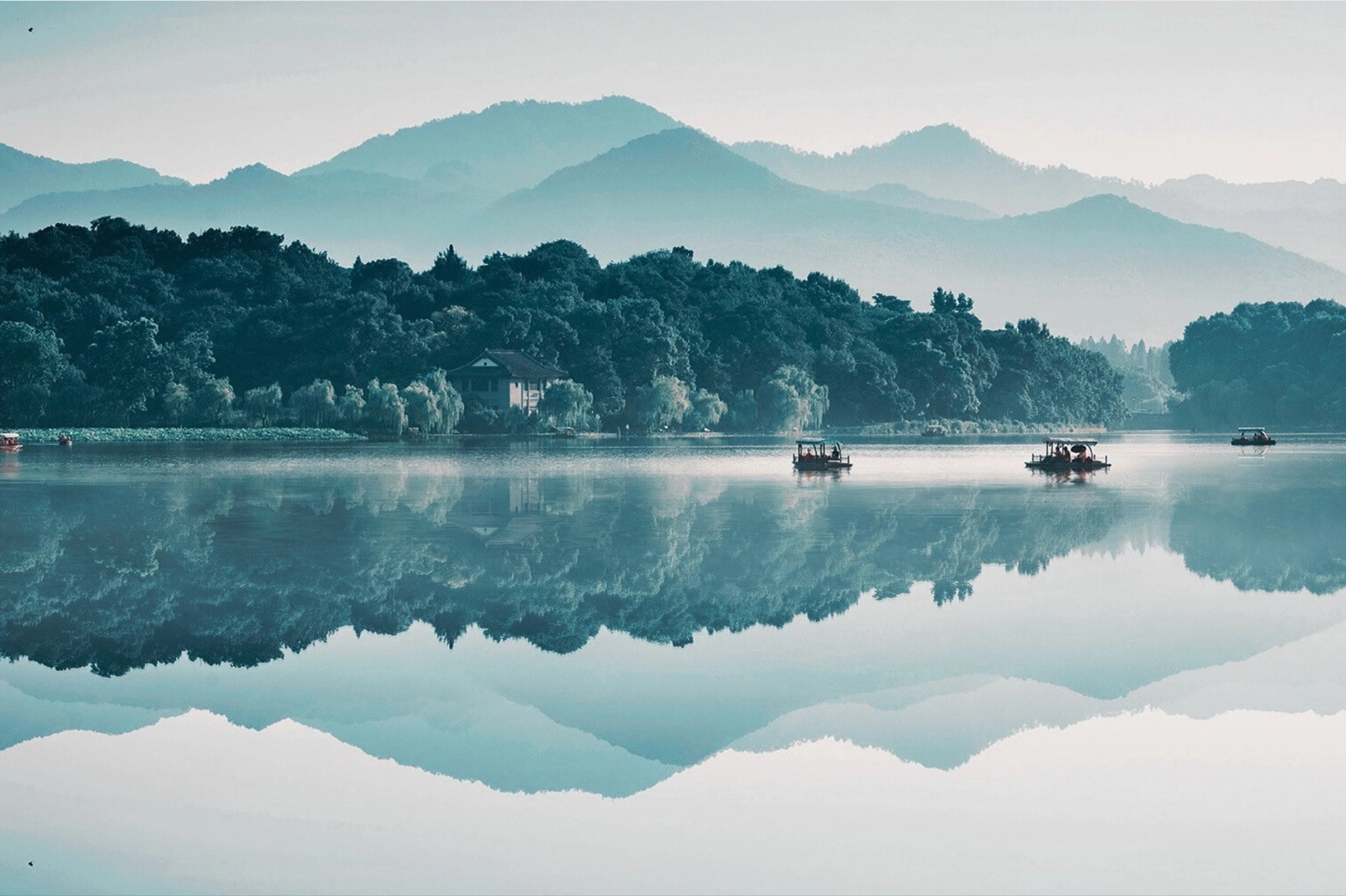 West Lake with traditional wooden boats and willow-lined shores