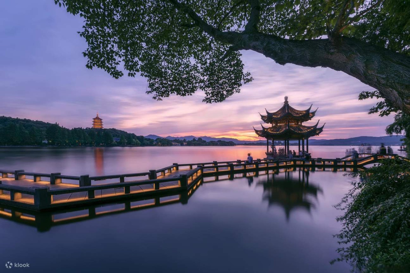 Leifeng Pagoda at sunset with calm water reflection in foreground