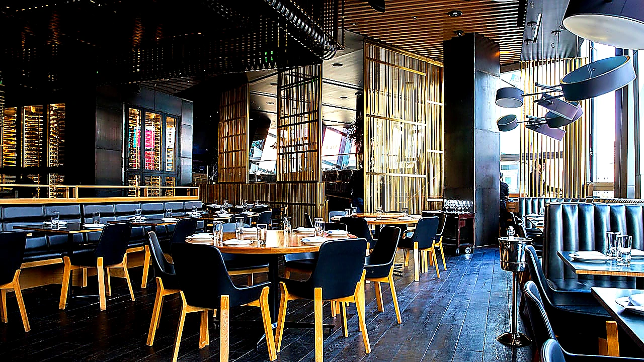 Vivid mid-article photo of chefs working under a well-lit CaptiveAire-style canopy hood