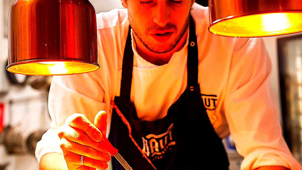 Vivid mid-article photo of chefs working under a well-lit CaptiveAire-style canopy hood