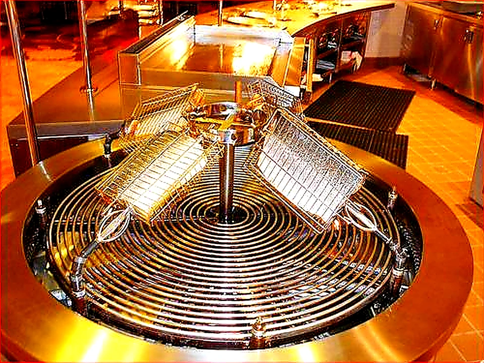 Bright colorful hero photo of a stainless commercial kitchen exhaust hood over a cooking line