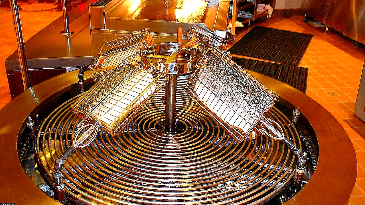 Sharp closing photo of a clean commercial kitchen with a full-length exhaust hood system