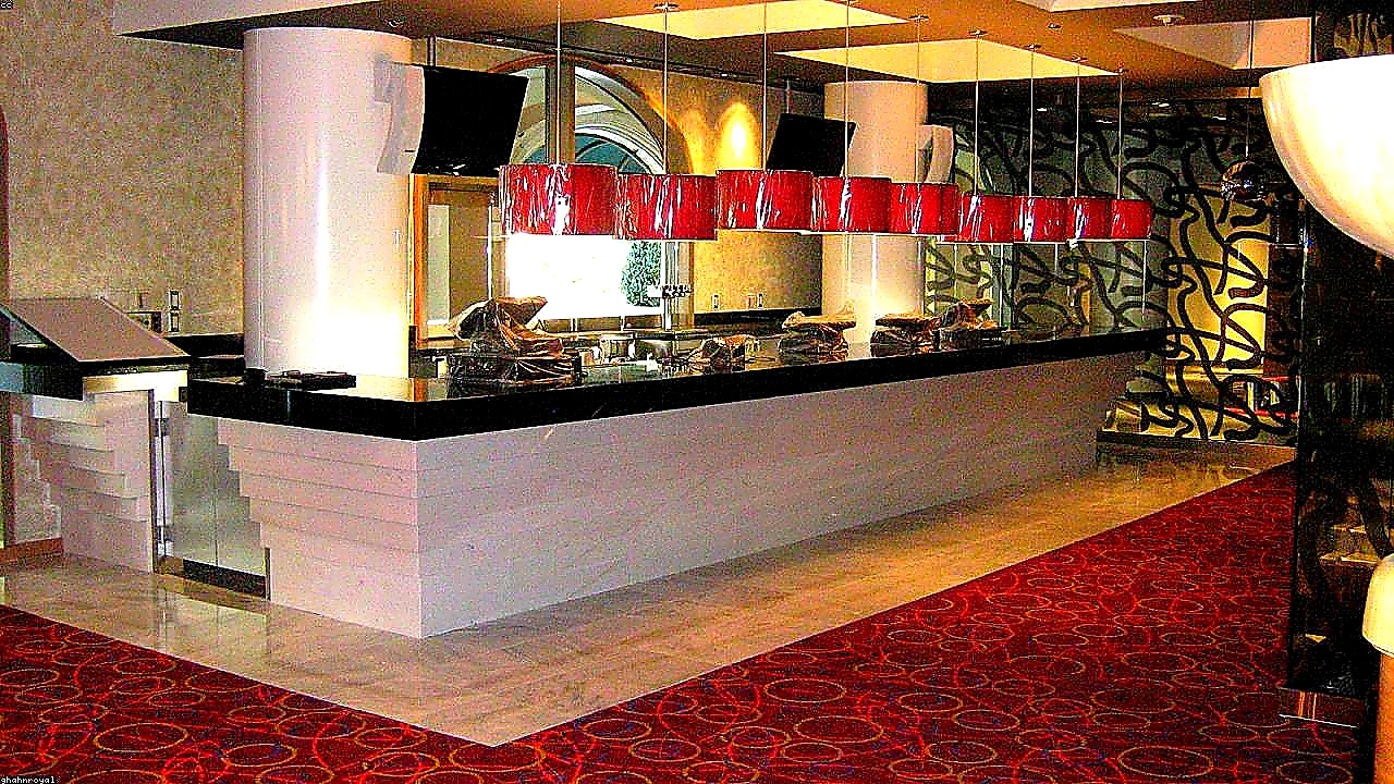 Bright colorful hero photo of a stainless commercial kitchen exhaust hood over a cooking line