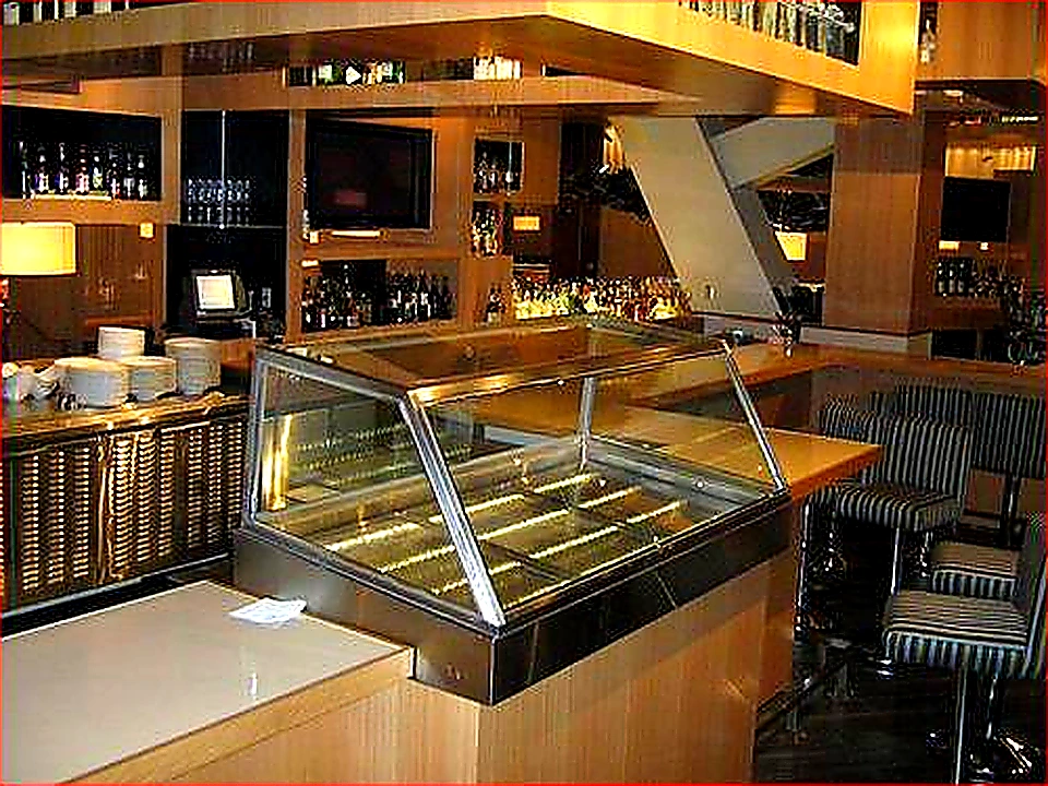 Sharp closing photo of a clean commercial kitchen with a full-length exhaust hood system
