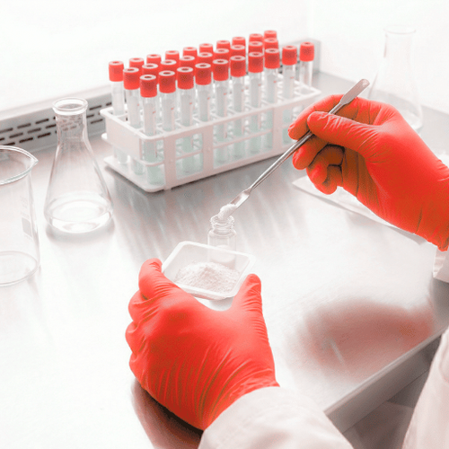 thare photo of chemist hands formulating formula in lab.png