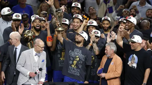 jalen brunson 11 of the new york knicks lifts the bill russell nba finals most valuable player award.webp