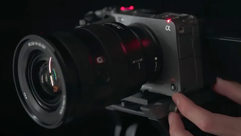 A hand holding the Sony FX3 camera