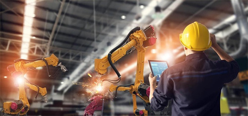 An industrial automation technician is setting up a big robotic arm.jpg