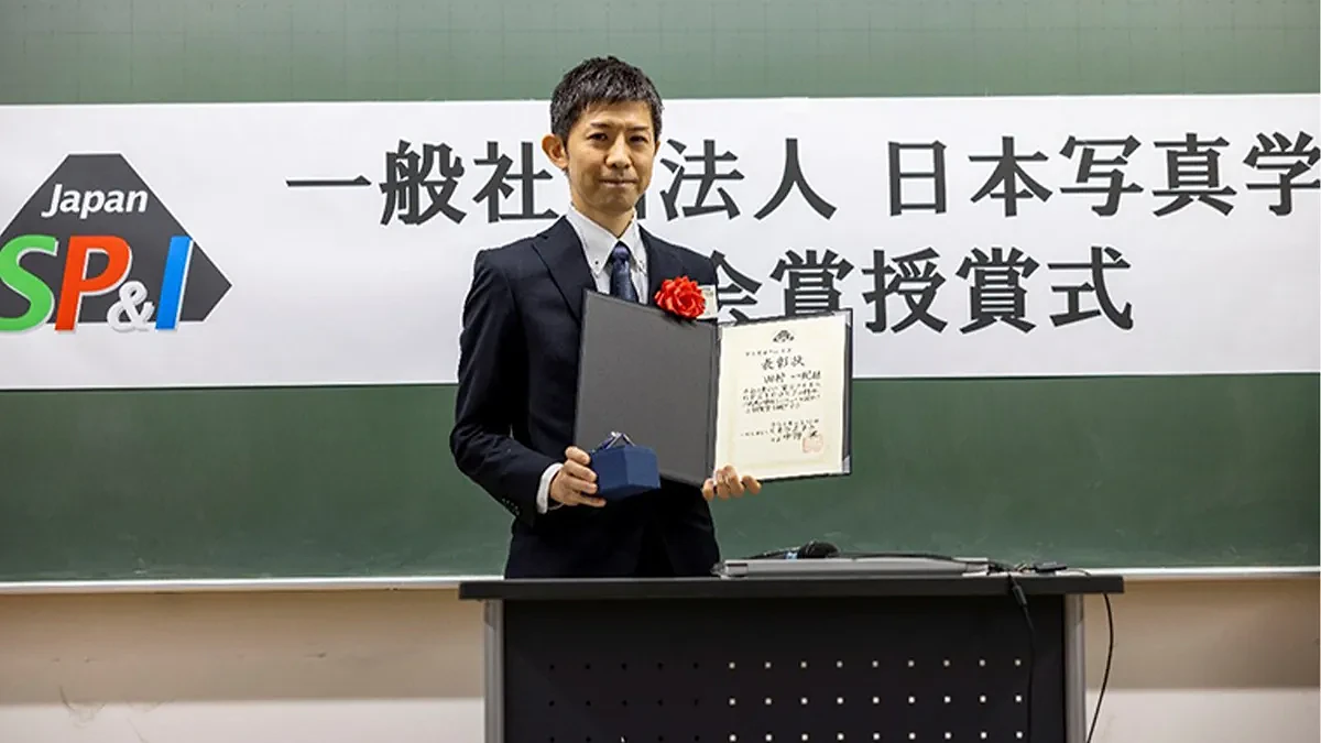 Man holding certificate.