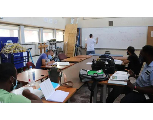 PTTI student developing analytical thinking and spatial reasoning skills reading a blueprint in a Ph.jpg