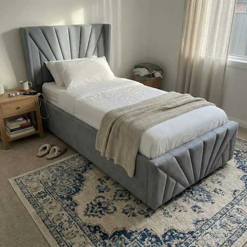A comfy single bed with storage in a simple grey fabric.png