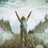 Girl praying for good weather on a rainy day.