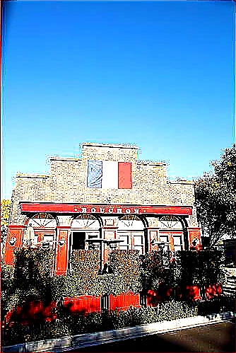 Sharp closing photo of a successful sunlit restaurant storefront with crisp signage and a bright planning workspace visible inside