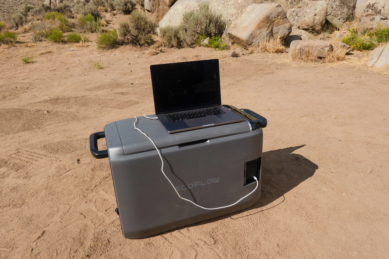 Laptop charging from the GLACIER Classic 45L battery at camp