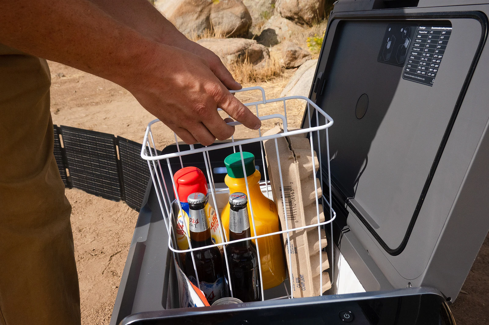 Basket of drinks and eggs being lifted from the GLACIER Classic fridge freezer