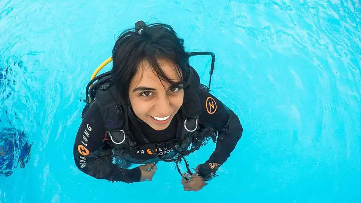 Portrait of Nadia Aly in water and wearing dive gear.