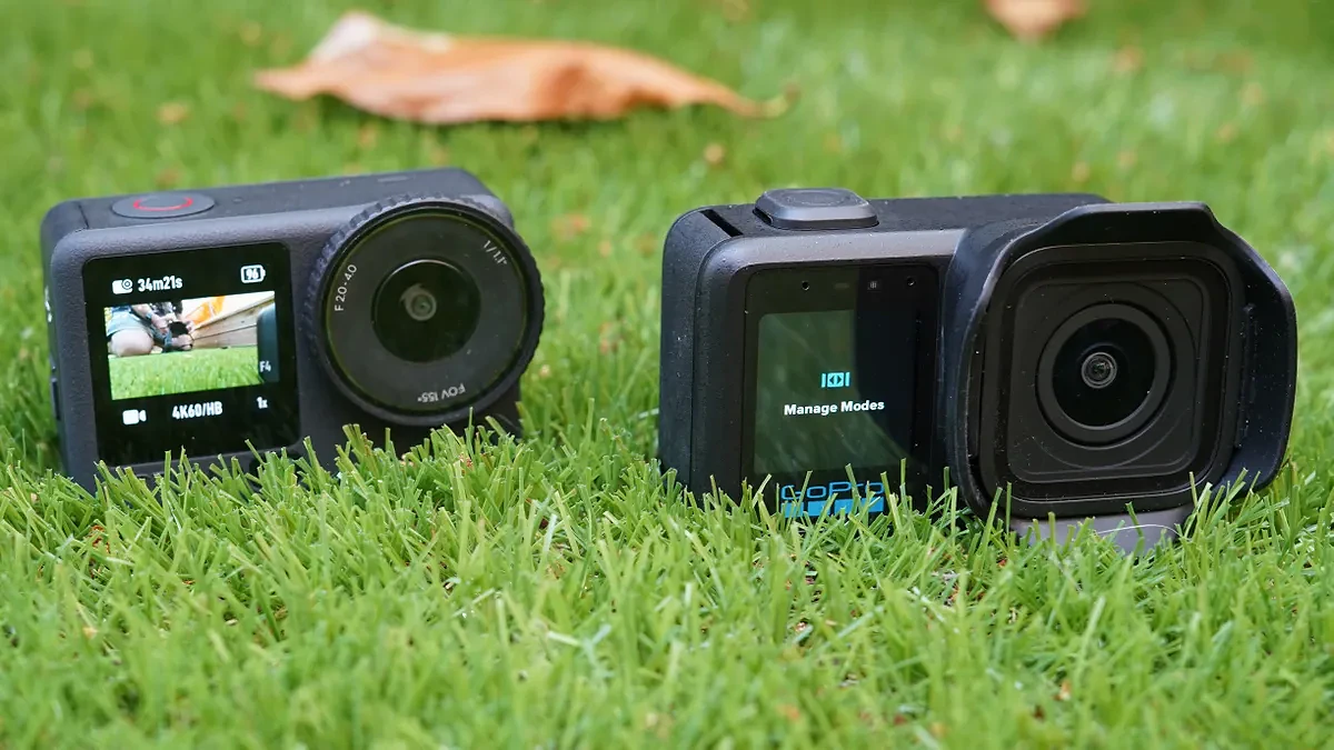 DJI Osmo Action 6 camera next to GoPro Mission 1 Pro sat on grass