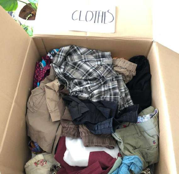 Carton of donated clothes ready for delivery