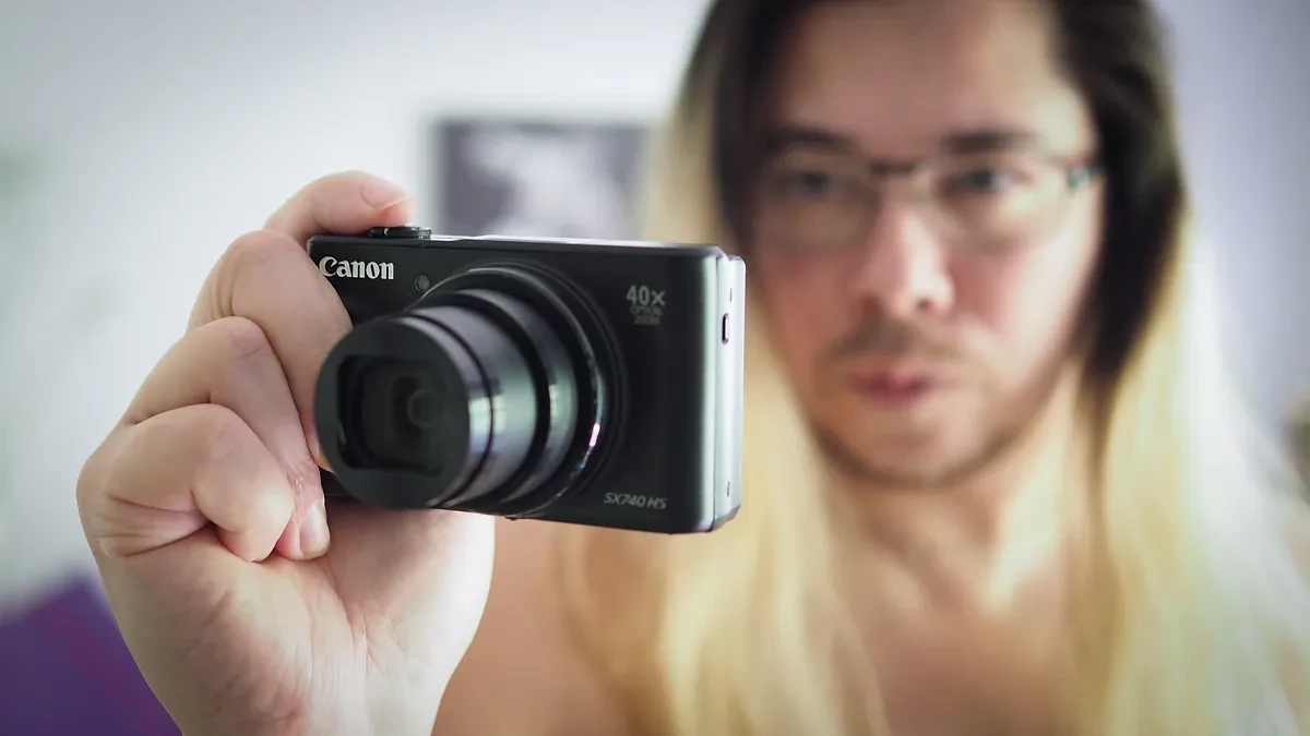 Photographer James Artaius holding the Canon PowerShot SX740 HS