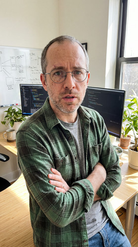 dv03 pete leaning desk arms up.jpg